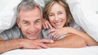 couple in bed happy