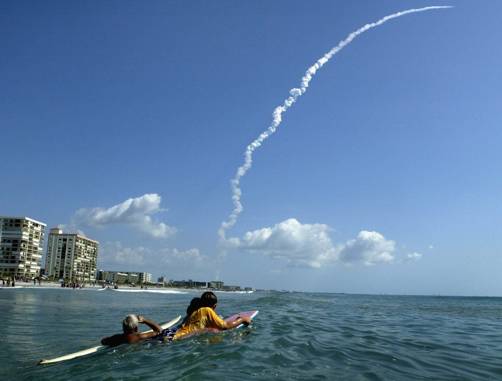 space shuttle rocket trail in the sky taken from the blue waters off the coast of Florida