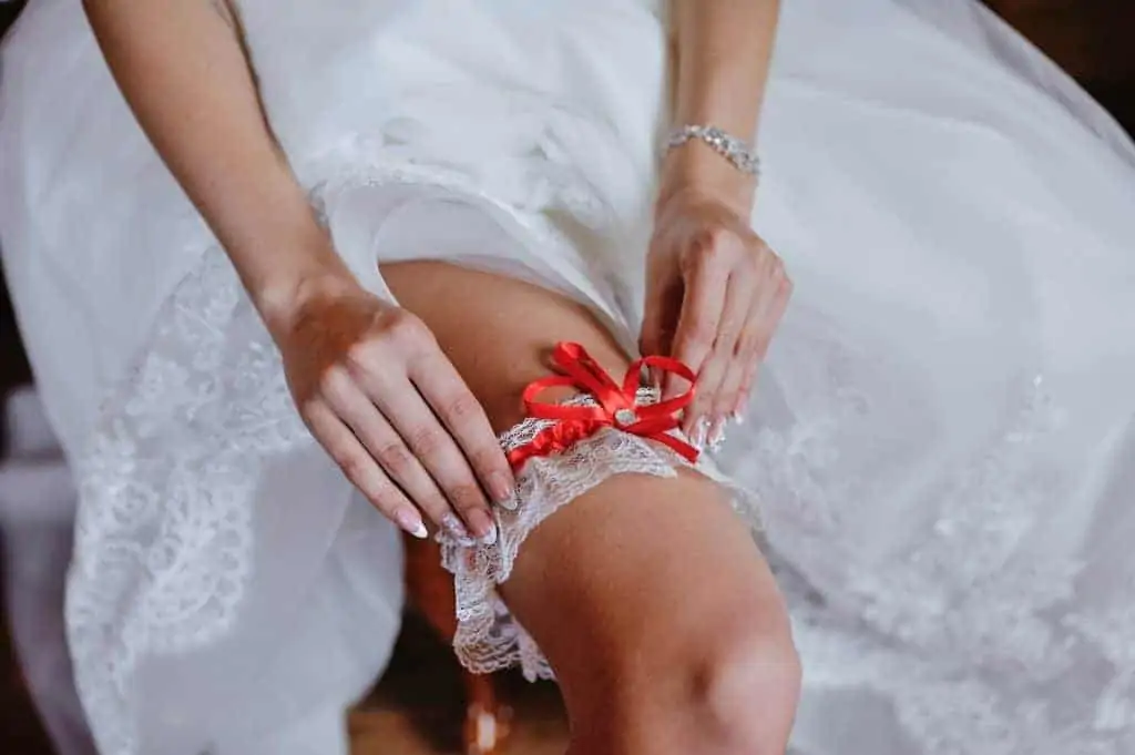 Bride wearing garter on leg