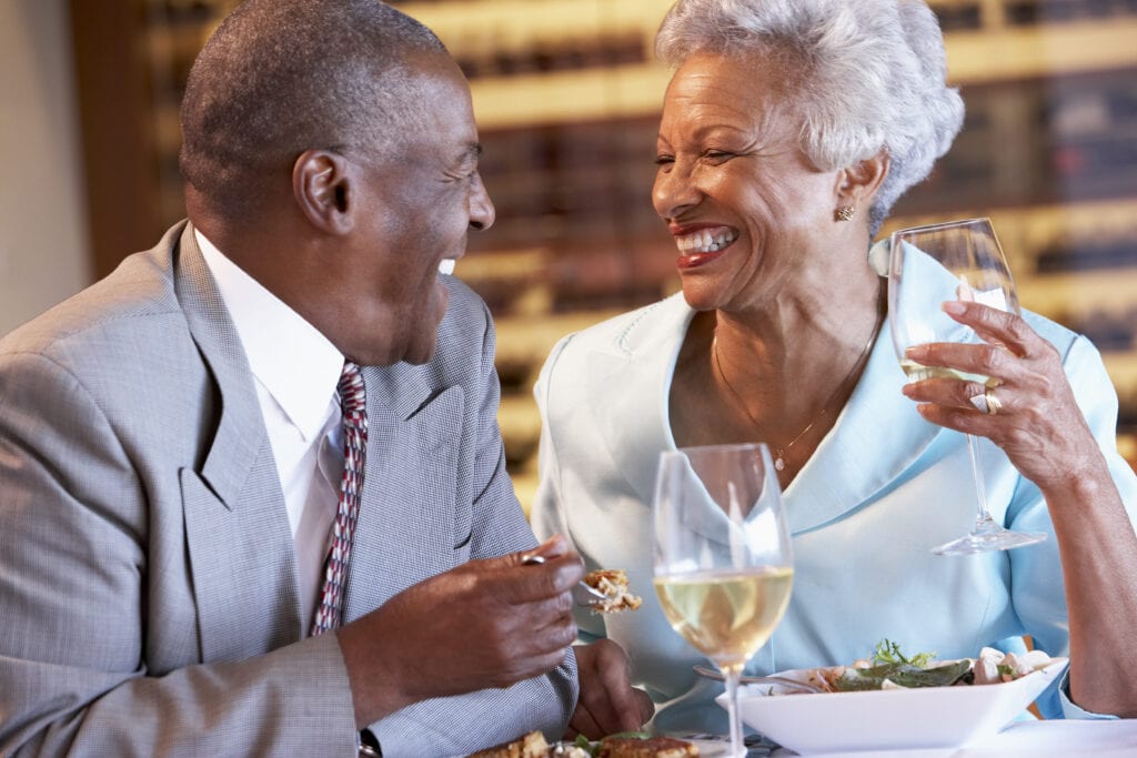 Older Black couple enjoying dinner