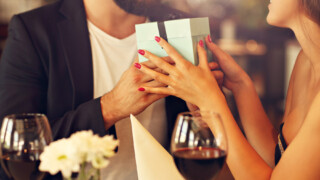 valentines day man holding gift with woman's hands