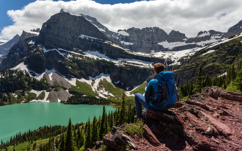 Hiker,In,Glacier,National,Park,Enjoying,The,View,Of,Grinnell