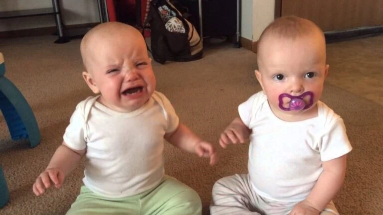Two babies, one crying