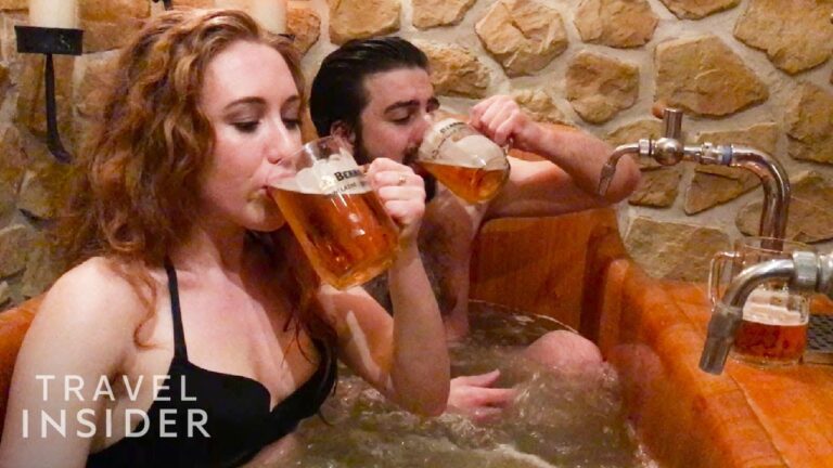 Couple chugging beer in a hot tub