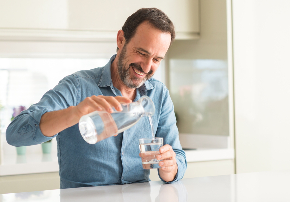 Middle,Age,Man,Drinking,A,Glass,Of,Water,With,A