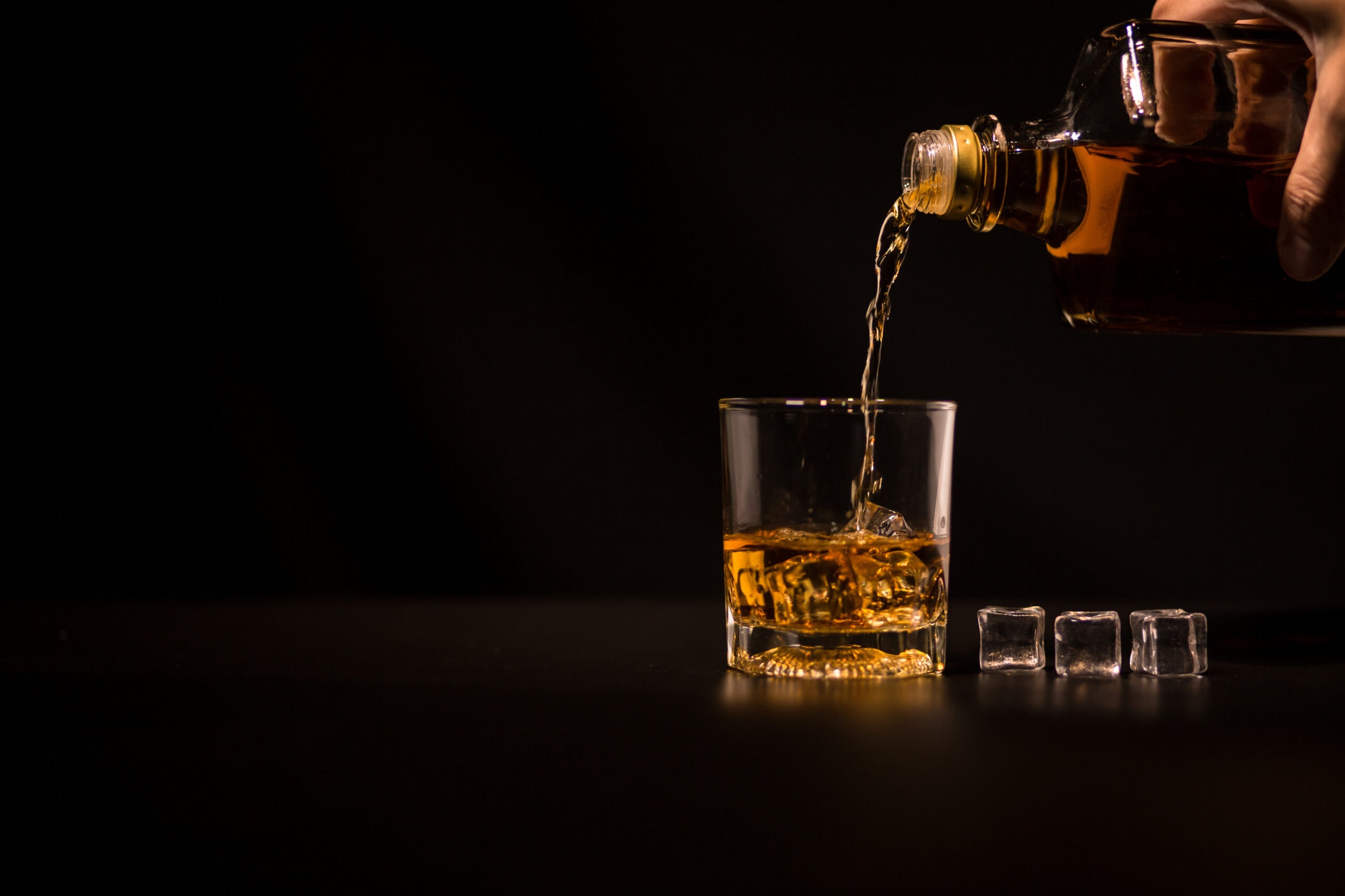Closeup,Barman,Pouring,Whiskey,Into,Glass